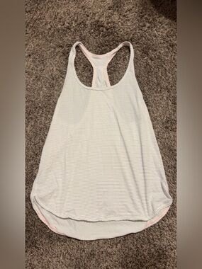 Size 6 Lululemon tank top! black and white striped with pink ruffles!